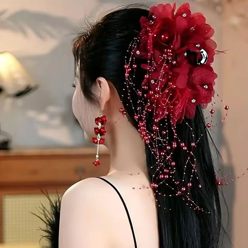 Red mesh flower pearl hair clip styled in an updo