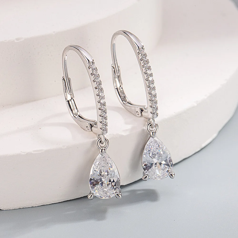 Pear drop hoop earrings styled on stand