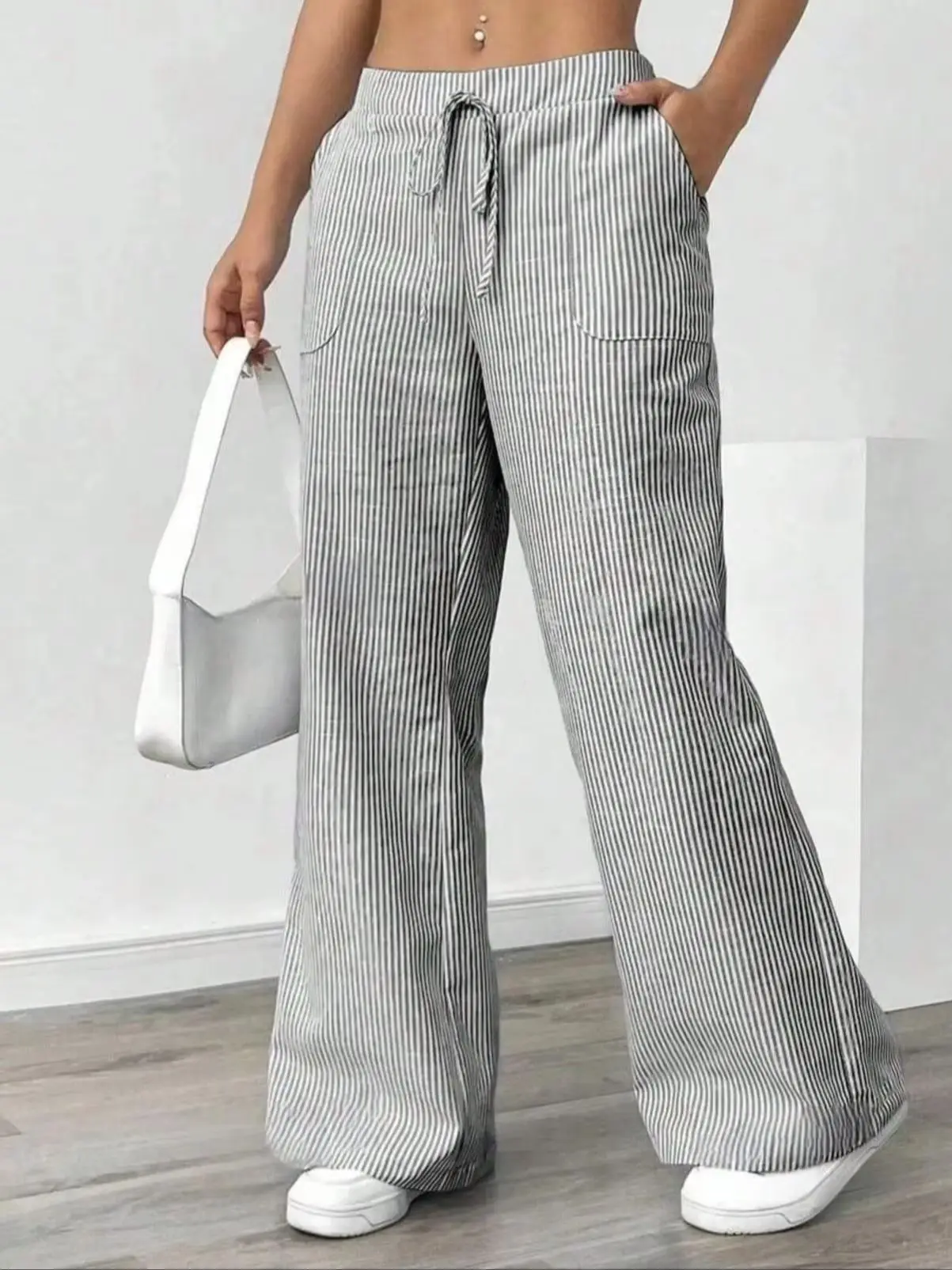 Striped wide leg pants for women, close-up of pocket and waist detail