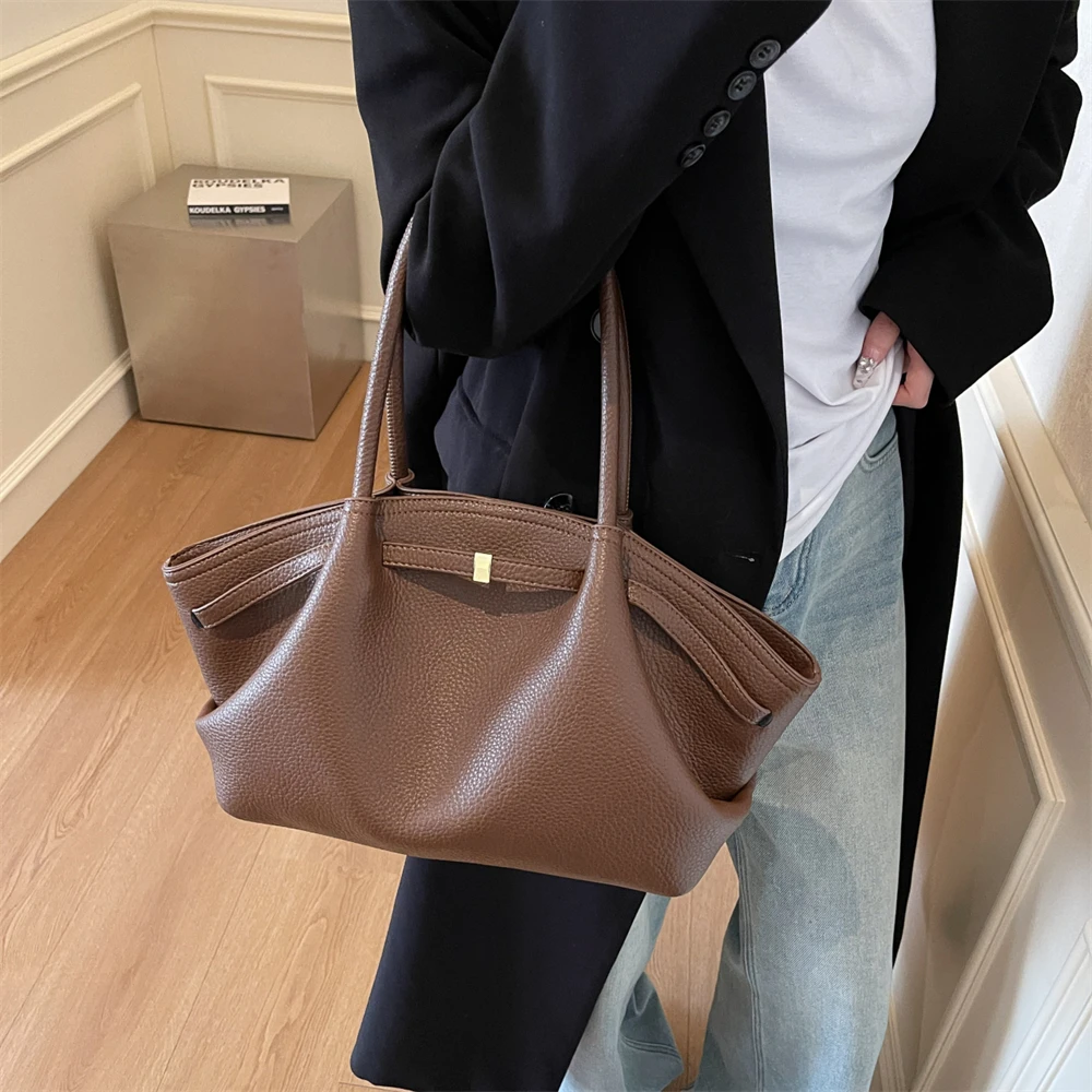 Burgundy tote bag worn on shoulder