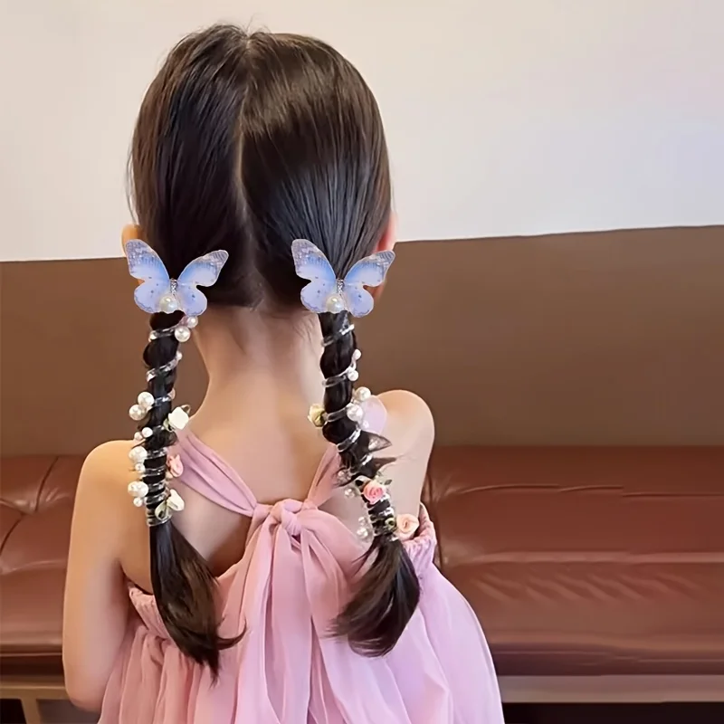 Braided pigtails styled with butterfly hair clips