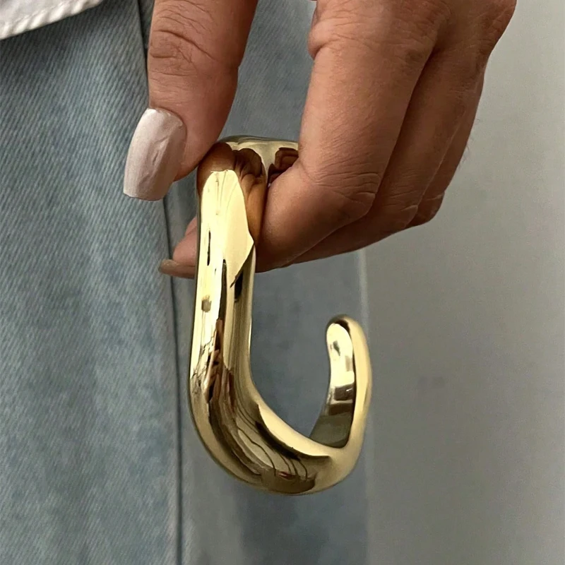 Woman wearing wavy resin bangles