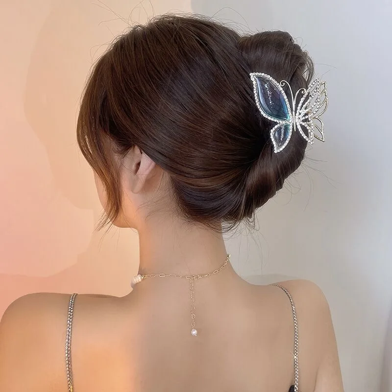Blue butterfly hair claw clamp on an elegant updo bun