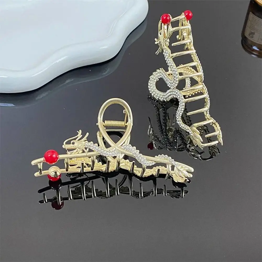 Gold dragon rhinestone hair comb in hand