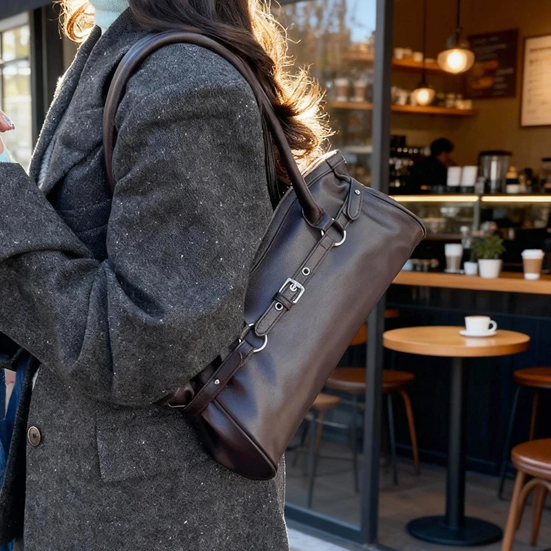 Woman wearing espresso brown leather tote bag in cafe