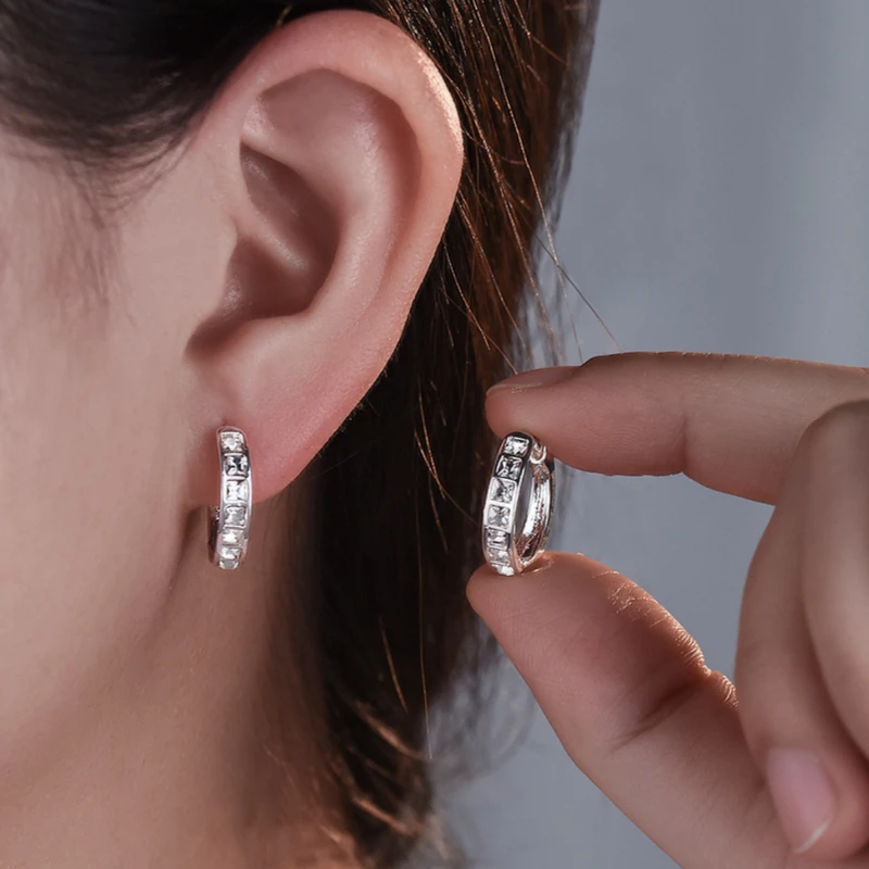 Woman wearing sterling silver round hoop earrings