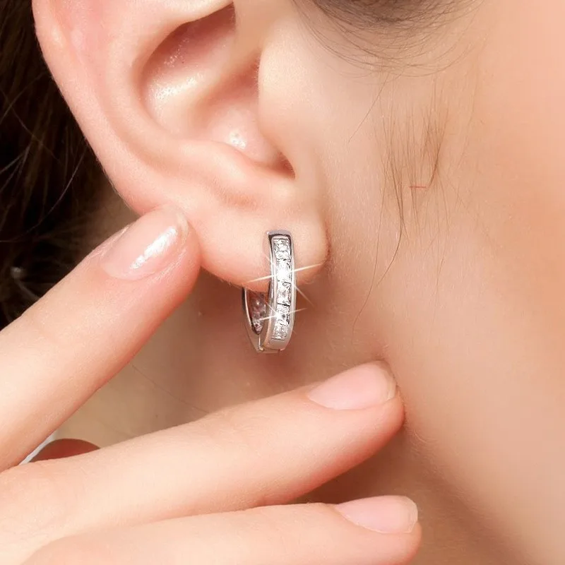 Close up of square CZ stones on silver hoop earring