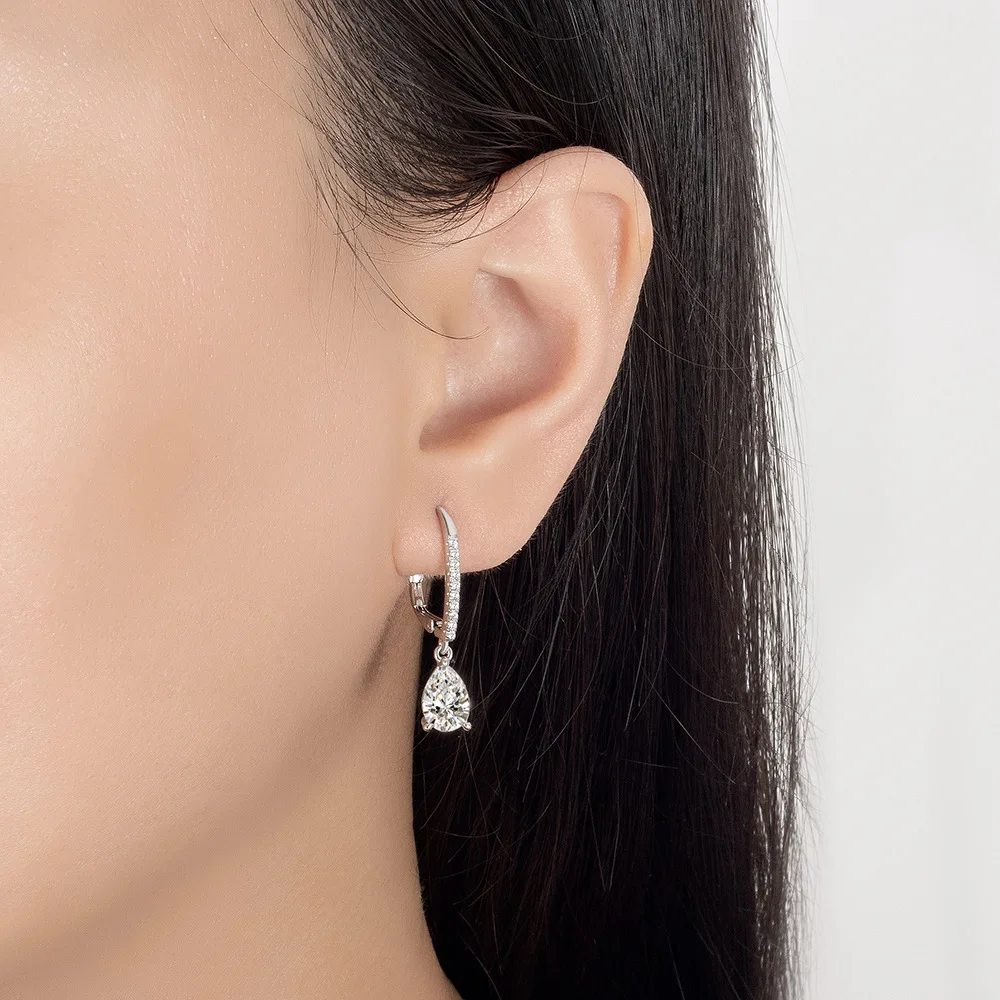Pear drop hoop earrings worn on model ear