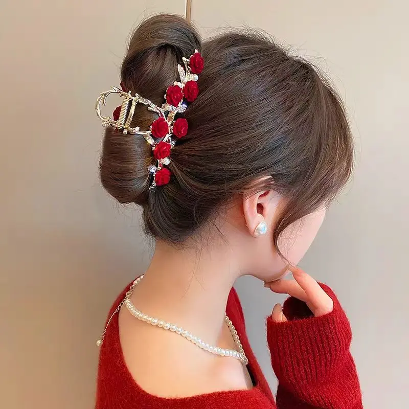 Rose flower hairpin worn in a low updo