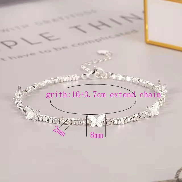 Woman wearing silver bead bracelet