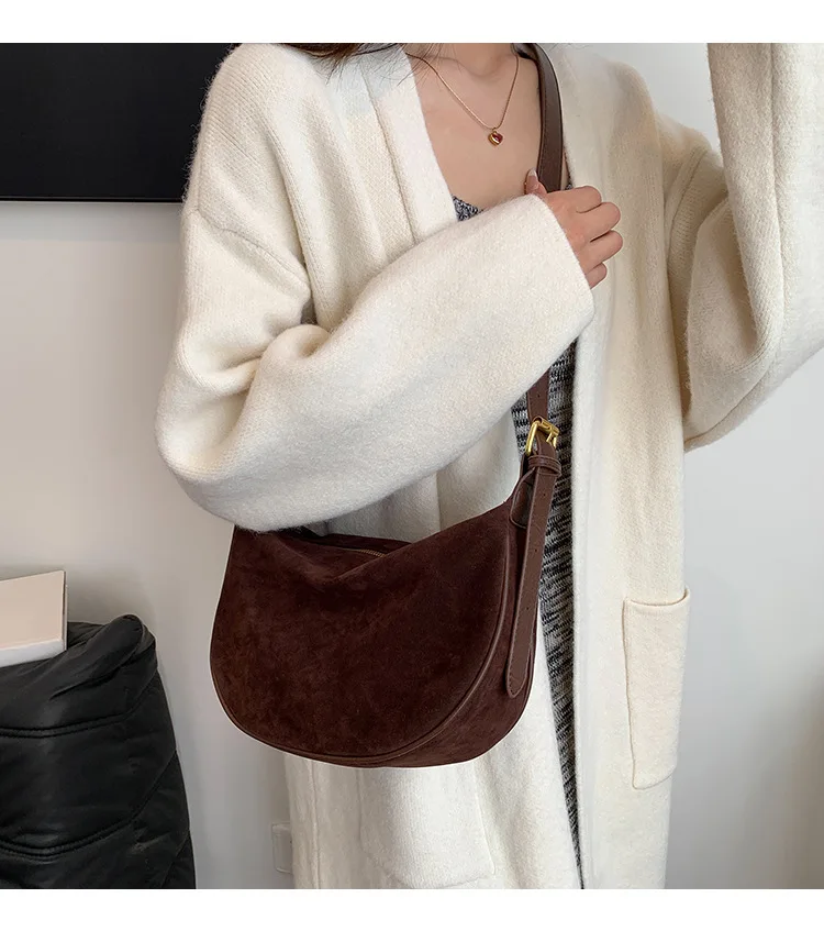 Woman wearing brown suede crossbody bag