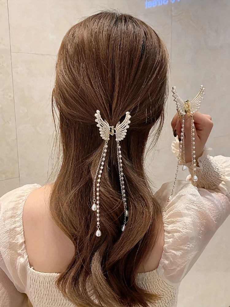 Woman wearing pearl butterfly hair clip in long hair