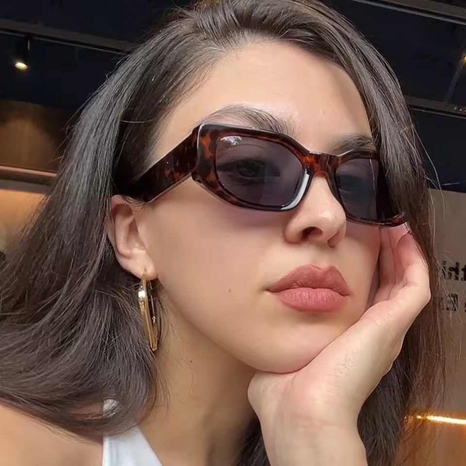 Woman wearing retro rectangle sunglasses